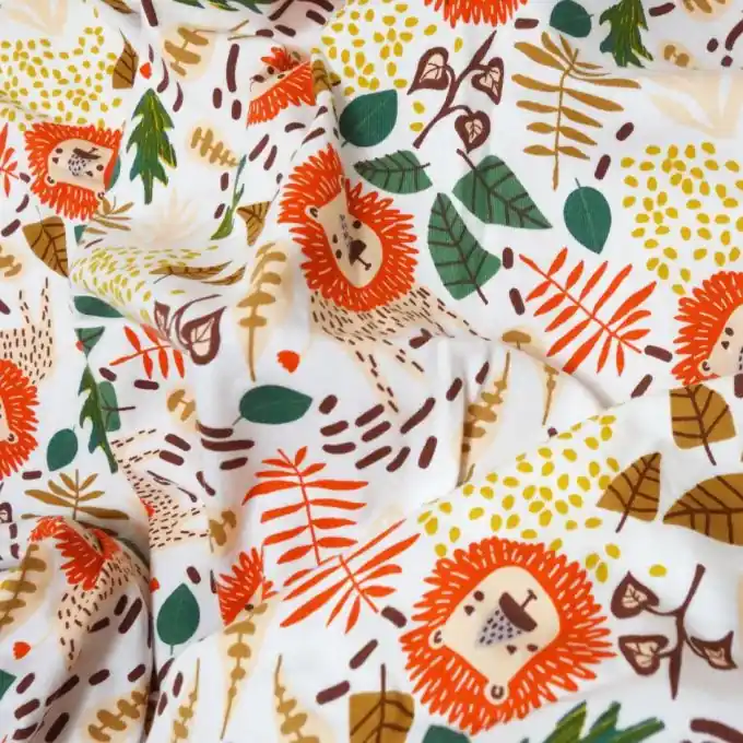 Aktuell Baumwolljersey weiß Löwen ockergelb grün