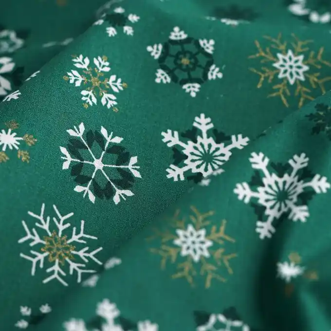Schneller Versand Baumwollstoff Schneeflocken gold tannengrün