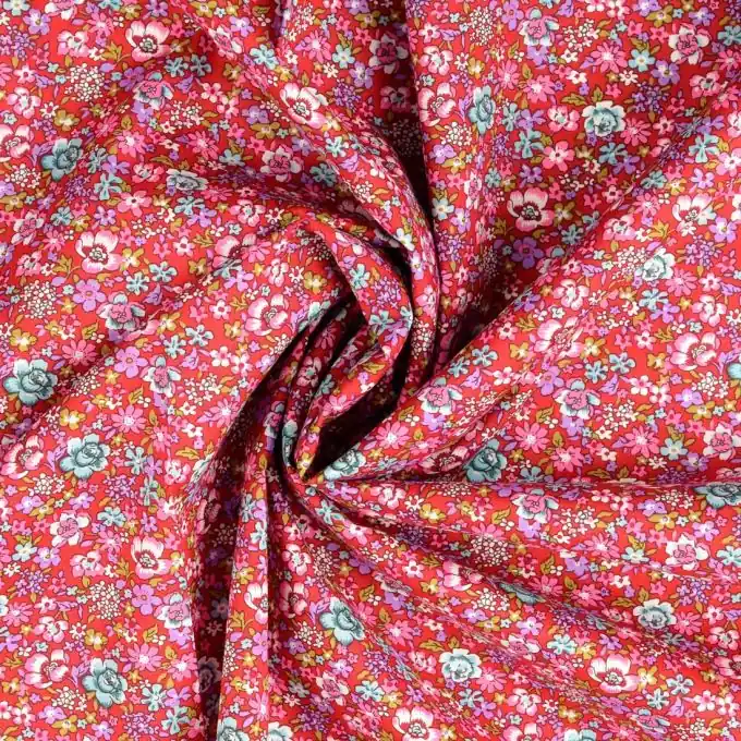 Bedruckte Popeline: Bunte Blumen auf rotem Stoff Super-Preis